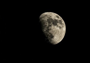 Close up view of gibbous moon in dark night sky. Detailed surface showing craters and features. Astronomy, space exploration concept.