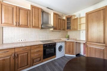 Modern Home Kitchen Interior with Wood Cabinets, Dining Table, and Natural Light