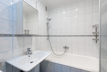 Home Bright Ceramic Tiled Bathroom With Combined Tub and Shower Design