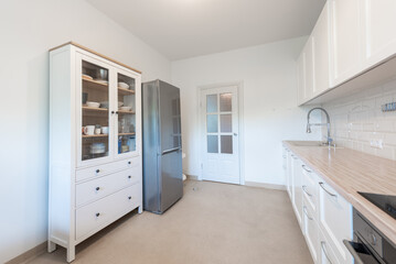 Modern Home White Kitchen Interior Design With Wooden Countertop and Open Storage Cabinet