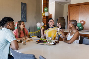 Friends enjoying conversation and snacks at home, sharing laughter and stories
