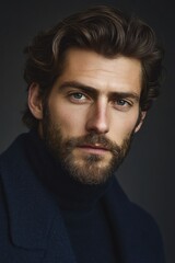 Fototapeta premium Close-up portrait of a man with a stylish beard and dark hair.