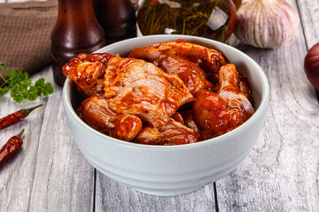 Raw marinated buffalo chicken wings