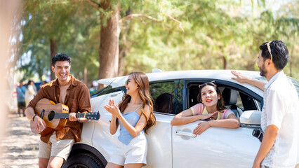 Fototapeta na wymiar Happy Asian man and woman road trip travel by car to the sea on summer beach holiday vacation. Group of People friends enjoy and fun outdoor lifestyle picnic party at tropical beach in sunny day.