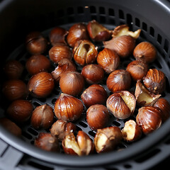 Obraz premium Golden Roasted Chestnuts in Modern Air Fryer Basket