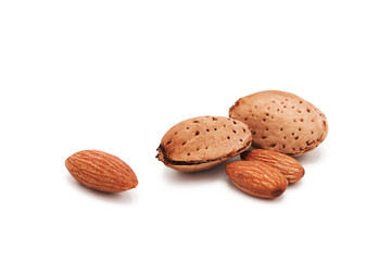 Organic fresh almond nuts whole in a heap in a shell and peeled isolated on white background.