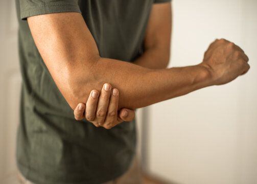Man having elbow pain soreness from injury 