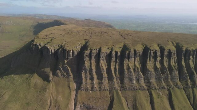 Spectacular 4K aerial video of flying about and above amazing Benbulbin mountain range at sunset, Sligo, Ireland