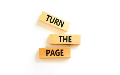 Turn the page symbol. Concept words Turn the page on beautiful wooden block. Beautiful white table...