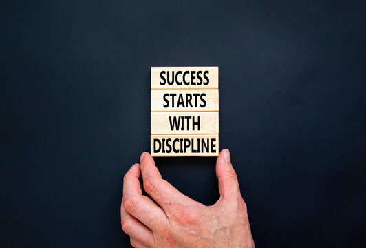 Success starts with discipline symbol. Concept words Success starts with discipline on beautiful wooden blocks. Beautiful black background. Business success starts with discipline concept. Copy space