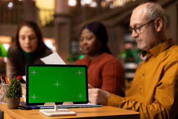 Team of calm and composed mature people studying next to copy space in a campus library, education and wisdom grows stronger with age. Older students group finishing their studies.