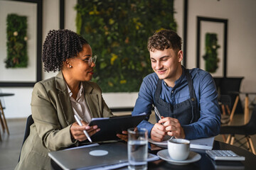 young man entrepreneur on the meeting with female financial adviser
