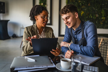 young man entrepreneur on the meeting with female financial adviser