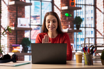 Mature woman attending an online class via video conference on internet, meeting with a teacher for important virtual lesson. Person studying hard for her master degree remotely.