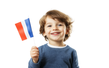Young child holding a paper French flag and waving with excitement in casual attire