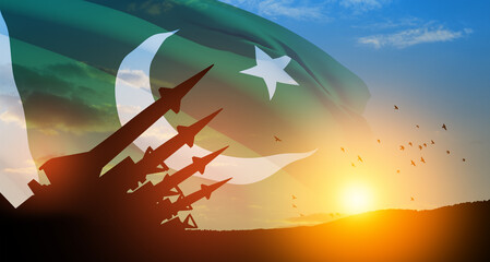 The missiles are aimed at the sky with birds at sunset with Pakistan flag. Nuclear bomb, chemical...
