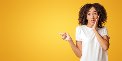 Huge sale, unexpected offer and amazing advertising. Surprised millennial african american woman...