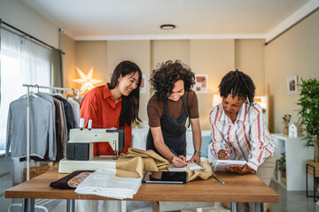 three females work together on new product at tailor studio