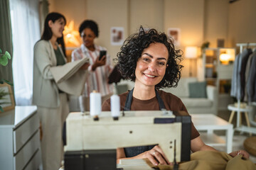 mature woman sew a new product on a sewing machine in the tailor studio