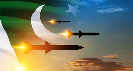 Fired missiles fly to the target. Missiles at the sky at sunset with Pakistan flag. Missile...