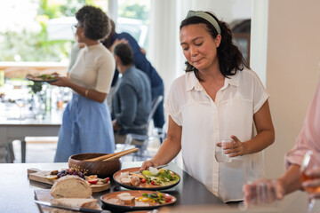 Guests enjoying buffet lunch with fresh salads and bread at wedding reception