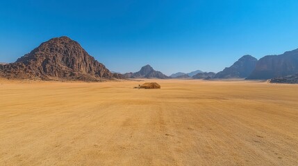 Fototapeta premium Arid landscape showing mountains and barren plains under a clear blue sky