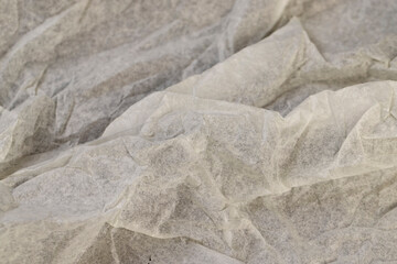 crumpled light-colored wrapping paper after prolonged use
