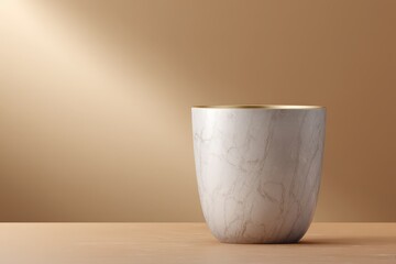 Elegant, light beige, ceramic vase on a light brown surface.