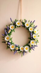 Fototapeta premium Hanging floral wreath with daisies and lavender on soft beige background