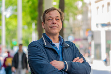 Urban portrait of a middle-aged man in casual clothes.