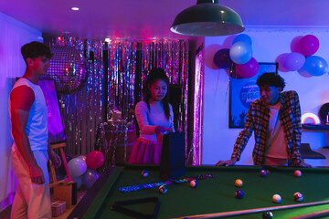Fototapeta premium Teens enjoying pool game at vibrant party with colorful balloons and decorations