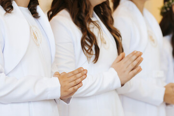 Child Praying with Folded Hands During First Holy Communion Ceremony