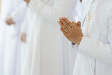 Child Praying with Folded Hands During First Holy Communion Ceremony