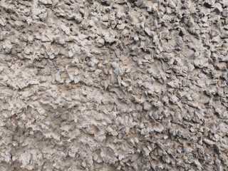 Rough concrete wall with dusty texture, natural wear and weathered surface