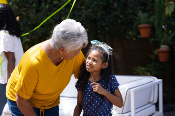 Fototapeta premium Grandmother and granddaughter sharing joyful moment at outdoor family gathering