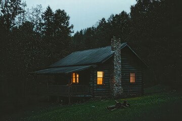Charming Wooden Cabin in the Woods with Stone Chimney and Porch