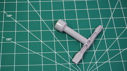 Green cutting mat with measurement grid lines, used for crafting, sewing, DIY projects, and precision cutting work.