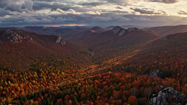 Dramatic autumn mountain landscape with rolling clouds at sunset