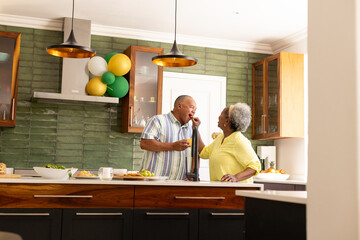 Senior couple in kitchen enjoying conversation and preparing meal together © wavebreak3