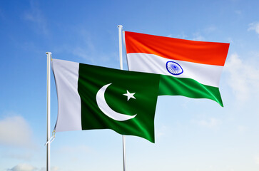 flags of pakistan and india over blue sky background.
