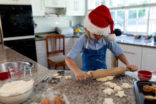 Rolling pin and star-shaped cookie cutters are resting on granite countertop in kitchen, copy space - Powered by Adobe