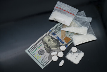 Plastic bag full of white powdered mephedrone drugs, drugs and pills easy money for the young dealer
