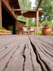 A warm and inviting outdoor scene is revealed in a close up of the weathered planks of wood, creating a rustic and natural look