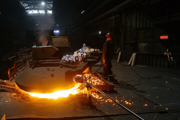 Metallurgists taking samples of liquid molten metal