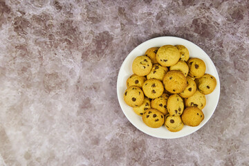 Chocolate chip cookies arranged to have copy space, isolated on white background