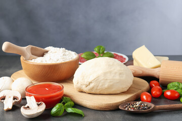 Making pizza. Different ingredients on gray textured table