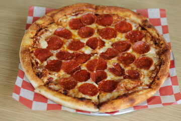 This vibrant image features a classic pepperoni pizza, sliced perfectly to showcase the melted cheese, helping to highlight the irresistible appeal of a favorite comfort food.