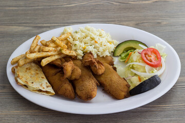 A delectable platter showcasing crispy fried fish, including shrimp and fries, accompanied by rice and a fresh salad, perfect for sharing.