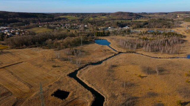 Aerial view of the upper course of the Wurm River from Starnberg to Leutstetten. The Leutstettener Moos nature reserve is located in the Leutstetten district of Starnberg, Upper Bavaria, Germany. 