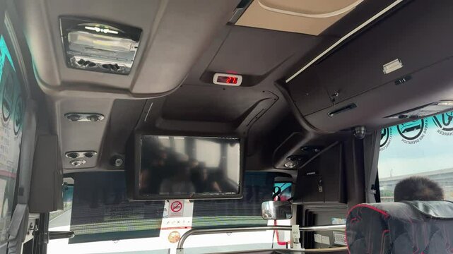 interior view of travel bus seats with yellow dim light. comfortable passenger bus interior with upholstered seats. row of seats inside a tourist bus